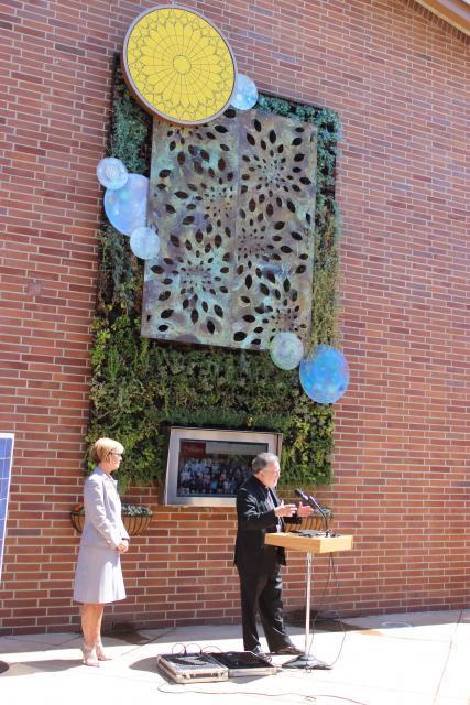 Bishop Soto and President Margo Reid Brown '81 in front of St. Francis High School's "Living Wall."
